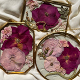 Brass hanging flower frame displaying pink-themed preserved blooms, handcrafted by Happihome for timeless floral wall décor.