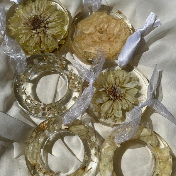 Handcrafted white-themed Christmas ornament with preserved flowers encased in resin, designed by Happihome for timeless holiday décor.