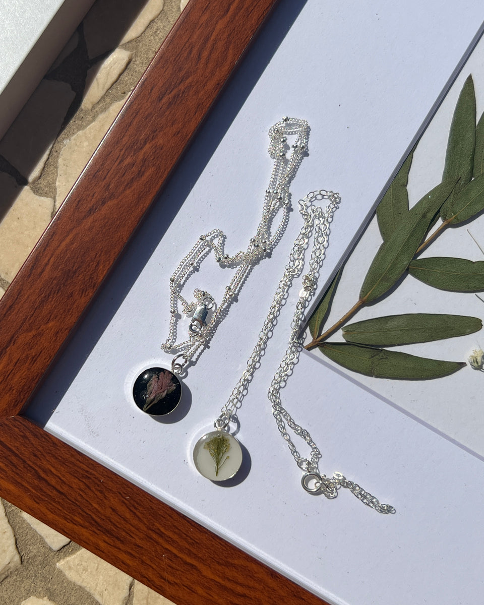 Sterling silver pendant necklace in round shape featuring preserved flowers, handcrafted by Happihome as a delicate floral keepsake.