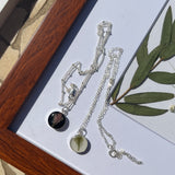 Sterling silver pendant necklace in round shape featuring preserved flowers, handcrafted by Happihome as a delicate floral keepsake.