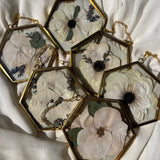 Set of six brass hanging ornaments featuring preserved flowers in resin, handcrafted by Happihome for timeless floral wall décor.