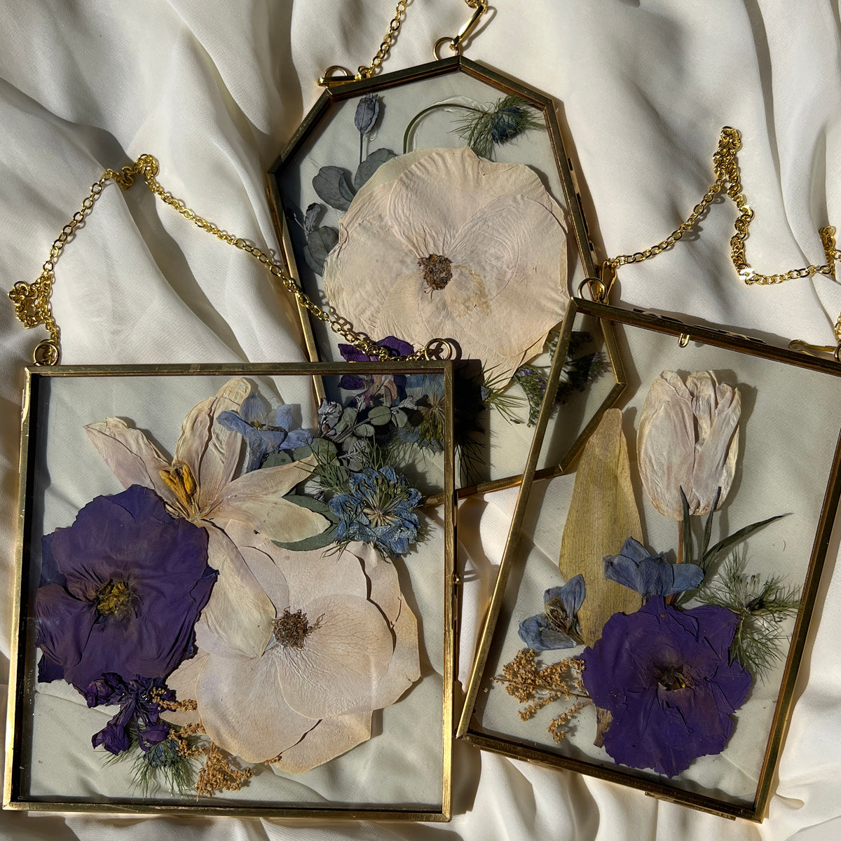 Brass hanging flower frame displaying purple-themed preserved blooms, handcrafted by Happihome for timeless floral wall décor.