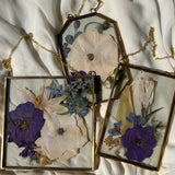 Brass hanging flower frame displaying purple-themed preserved blooms, handcrafted by Happihome for timeless floral wall décor.