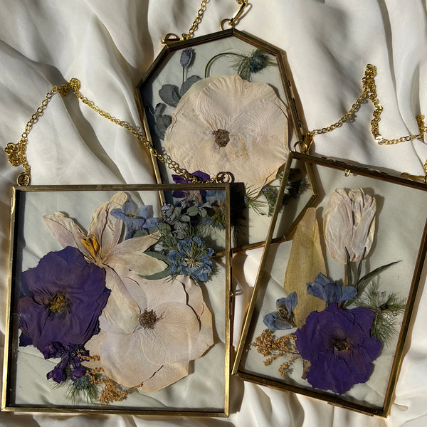 Brass hanging flower frame displaying purple-themed preserved blooms, handcrafted by Happihome for timeless floral wall décor.