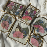Brass hanging flower frame displaying preserved blooms, handcrafted by Happihome for timeless floral wall décor.