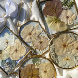 Brass hanging flower frame displaying preserved blooms, handcrafted by Happihome for timeless floral wall décor.