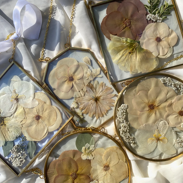 Brass hanging flower frame displaying preserved blooms, handcrafted by Happihome for timeless floral wall décor.